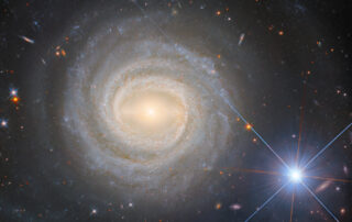 hubble-captures-a-bright-galactic-and-stellar-duo
