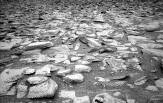 sols-4398-4401:-holidays-ahead,-rocks-under-the-wheels