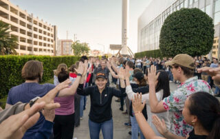 NASA astronaut Anne McClain smiles and high fives SpaceX employees