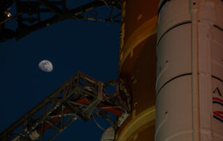 Moon Seen Shining on Full Artemis II Stack at Launch Pad 39B