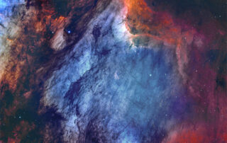 The Pelican Nebula in Gas, Dust, and Stars